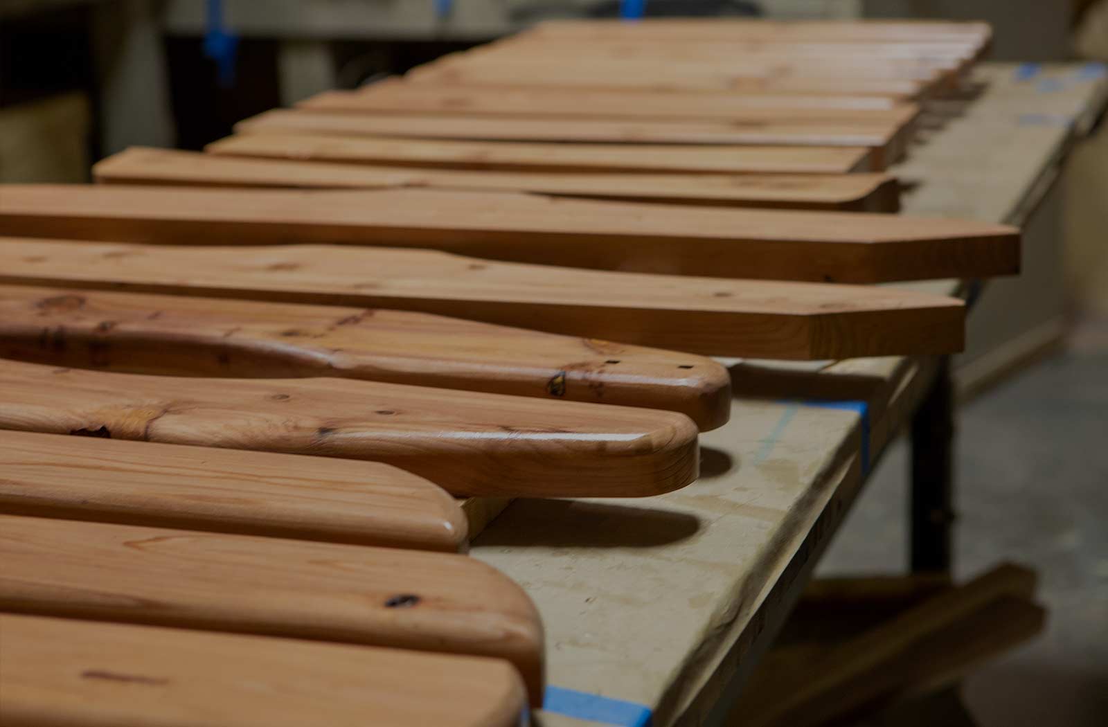 a table with 10's of custom made pieces of wood to be varnished or painted