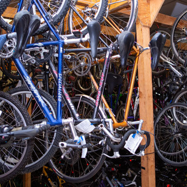 images of 100's of bikes hanging in the bike shop at the Toy Project headquarters